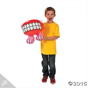 Kid holding inflatable teeth
