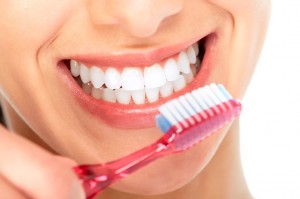 Woman holding toothbrush with white teeth