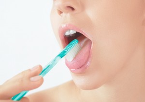 Woman brushing tongue