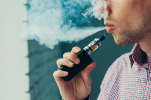 Man exhaling vapor from an electronic cigarette
