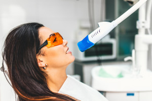 Teeth whitening in dental clinic for female patient